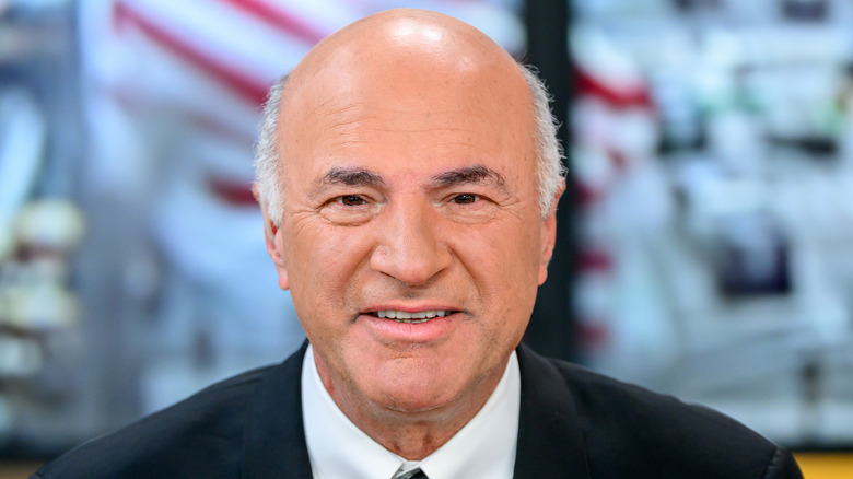 A close-up of Kevin O'Leary smiling into the camera.