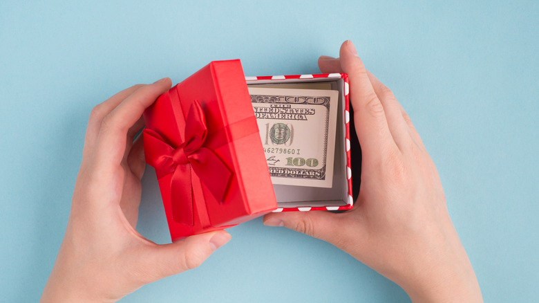 $100 bill in a present box