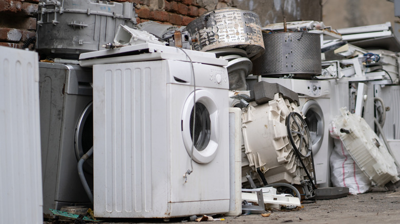 an old washing machine with other old appliances