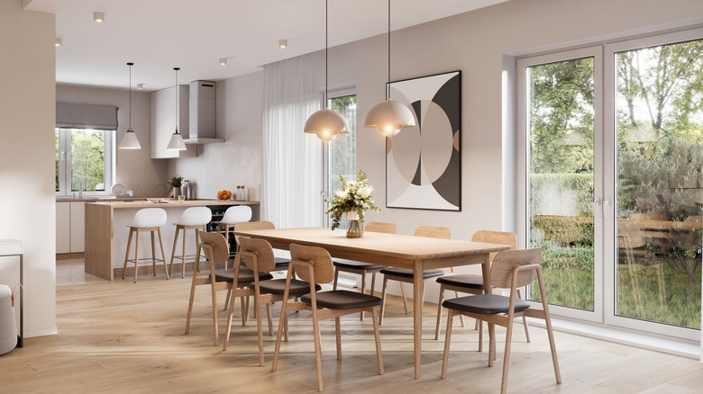 Modern light pendants hang over a kitchen table.