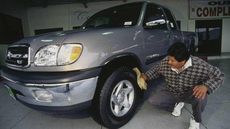 An early Toyota Tundra model on sale at a dealership.