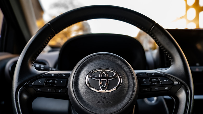 A steering wheel with the Toyota logo.