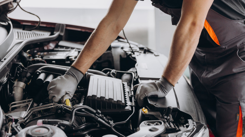 Person working on car engine