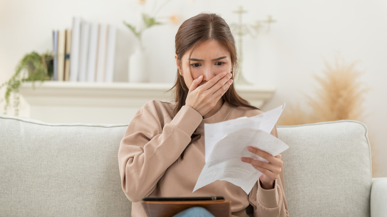 woman looking worried while reading her statement