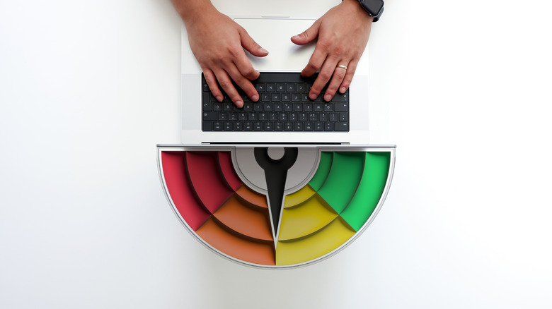 credit score dial and a laptop