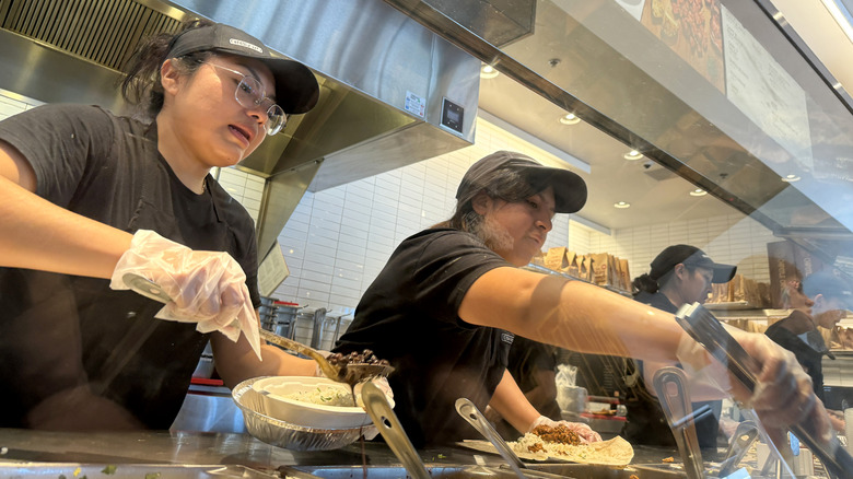 Chipotle staff members serving customers