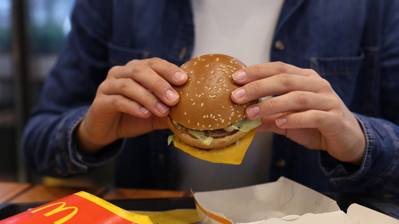 A man eating McDonald's burger