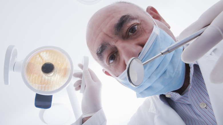 Dentist looking down at patient