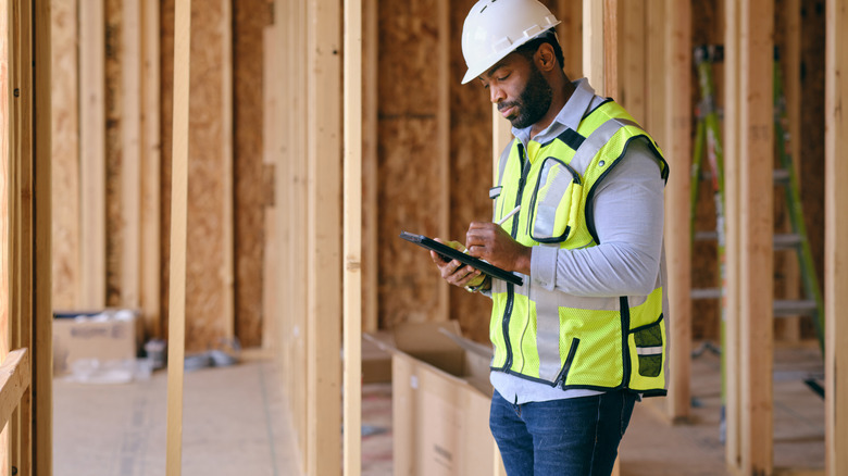 Man inspecting a home under construction
