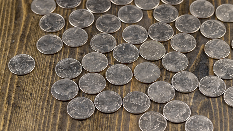 Tabletop covered in various quarters