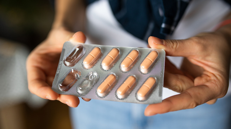 holding a pill pack