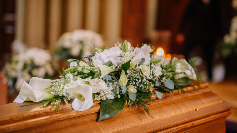 A coffin covered in flowers