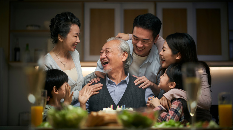 Grandfather surrounded by grandchildren