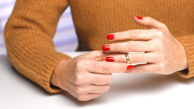 Woman removing her wedding ring