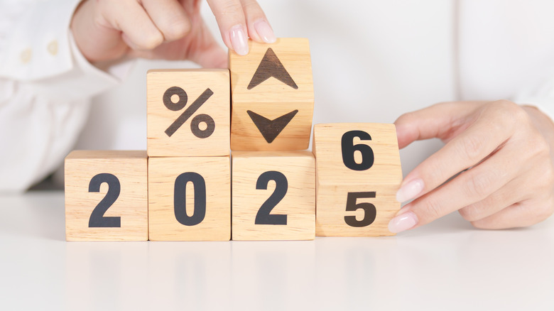 Wooden blocks changing 2025 to 2026 with an % sign