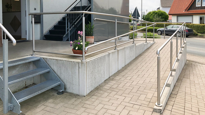 Entrance to home with steps and long wheelchair ramp