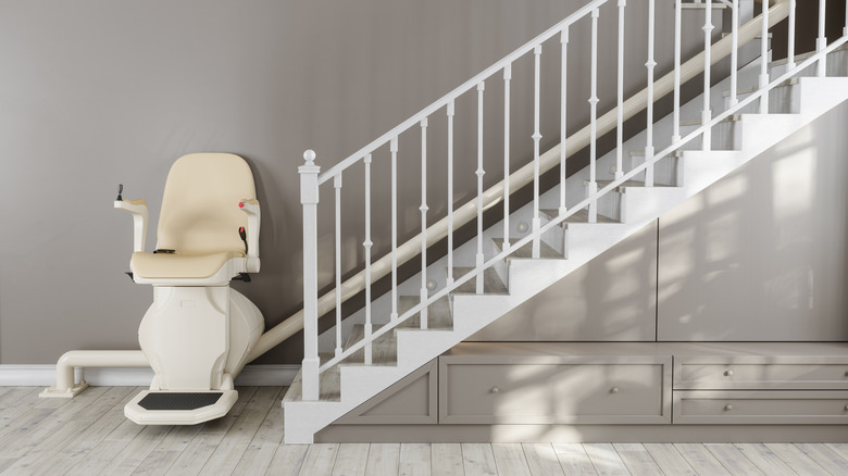Stairlift chair at the bottom of the stairs in a home