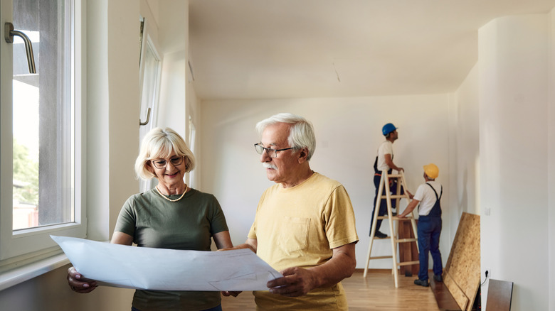 Couple looking at home renovation plans.