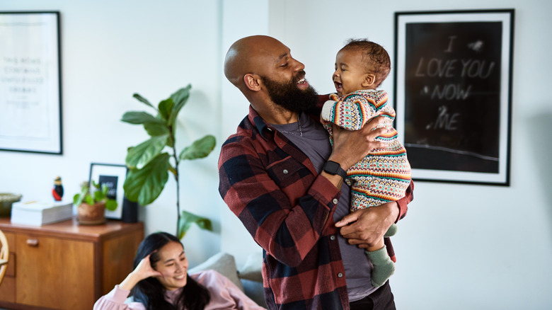 Couple with an infant in their living room