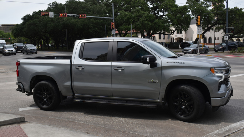 A grey and black Chevy Silverado 1500 pick-up truck cruising near Herman Park in Houston