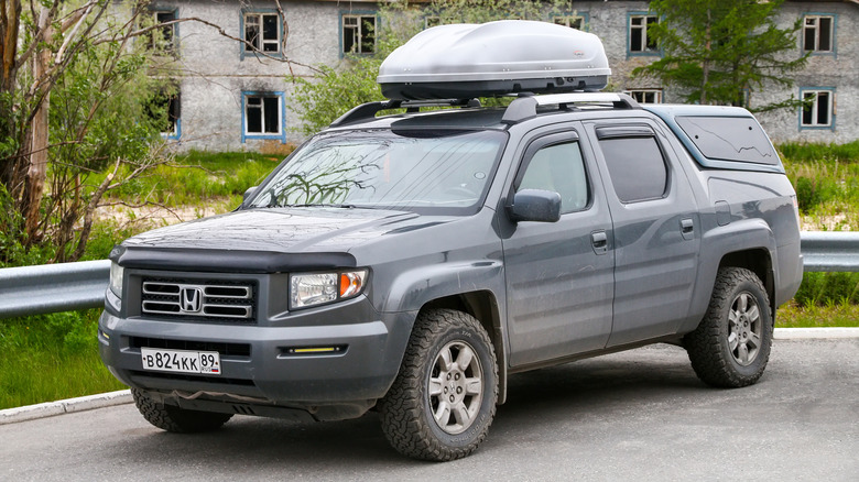 A Honda Ridgeline parked on a city street.