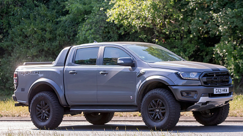 A grey Ford Ranger pick up truck car driving on a British road.