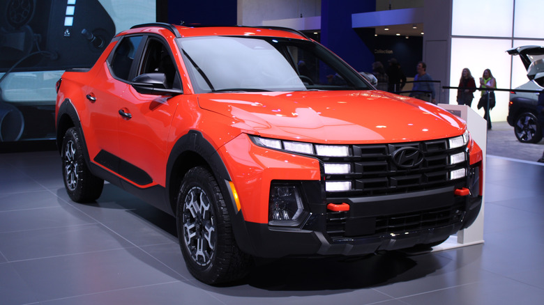 An orange Hyundai Santa Cruz on display.