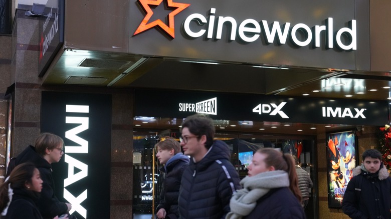 Moviegoers walk past a Cineworld entrance displaying IMAX, 4DX, and Superscreen signs