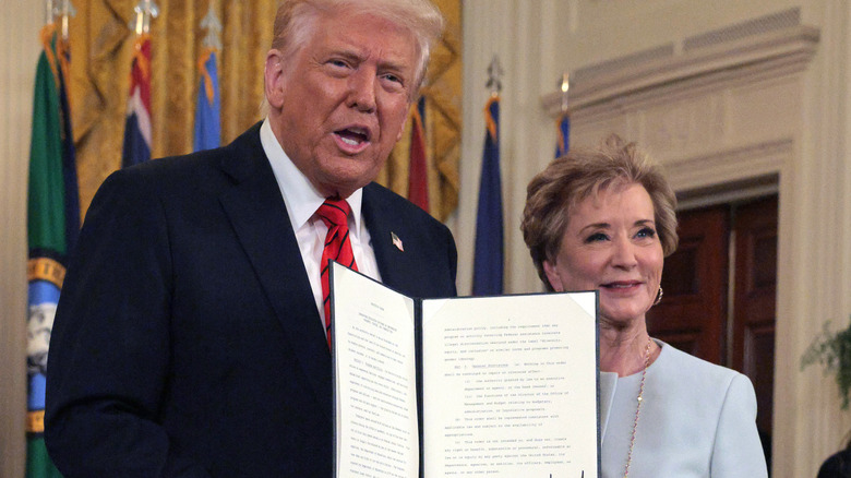 Donald Trump and Linda McMahon in the White House, holding Executive Order