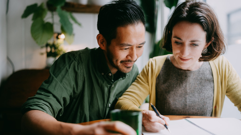 Couple budgeting to save for home.