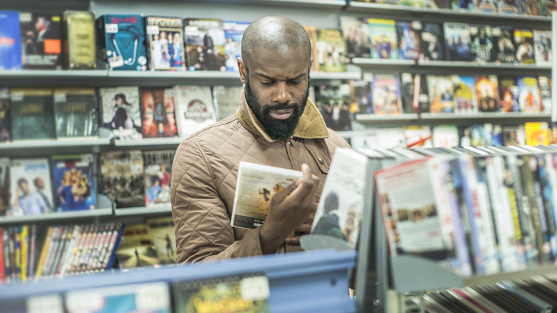 Man shopping for DVDs in store