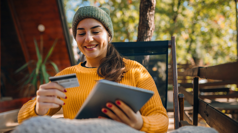 Young woman using a digital tablet on a sunny autumn day