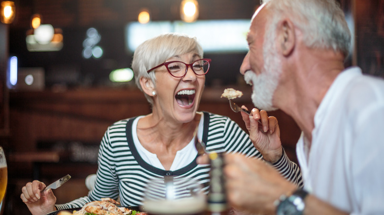 Active senior couple having a lunch in the restaurant