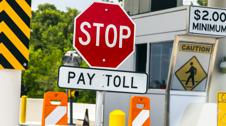 A pay toll sign at a toll bridge