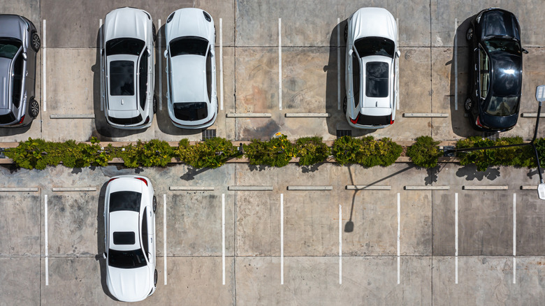 Aerial view of parking lot with parked cars