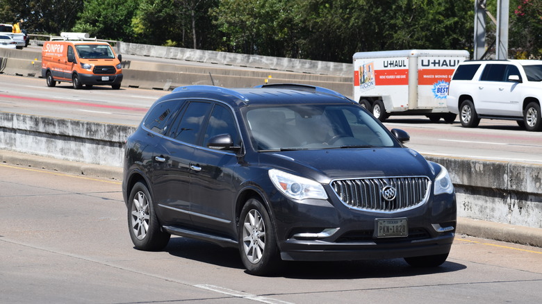 A black Buick SUV driving down a highway near Houston.
