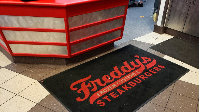 Freddy's restaurant floor mat near the counter