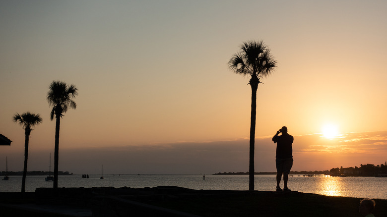 A man standing near the water in St. Augustine at Sunrise