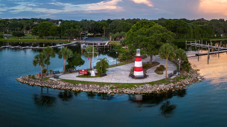 Red and white Mount Dora Lighthouse overlooks Lake Dora at Grantham Pointe Park.