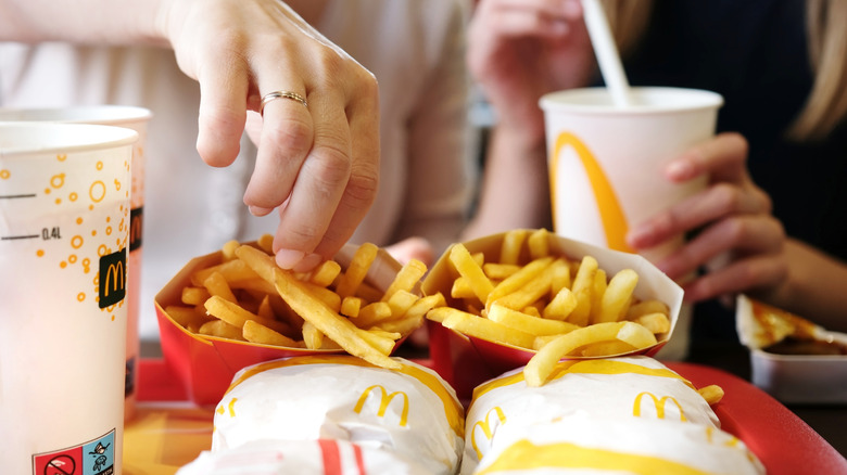 closeup of two people eating McDonald's