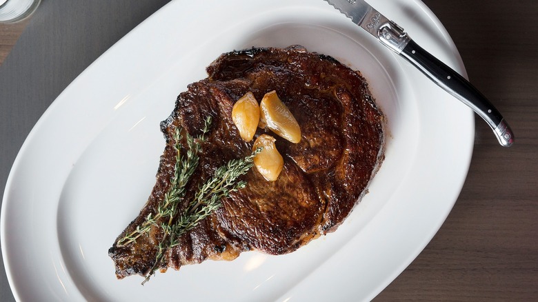 Ribeye steak with garlic on top
