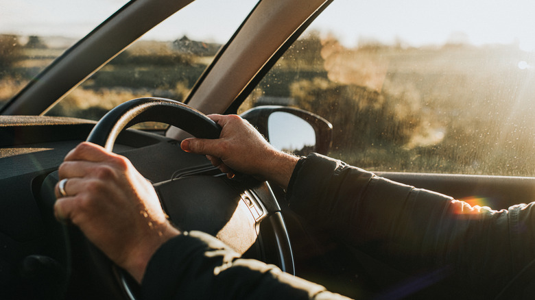 Hands on the steering wheel of a car