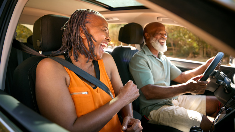 Happy older couple in car