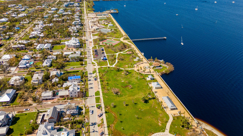 A drone image of Punta Gorda, Florida, with houses and a waterfront park in view.