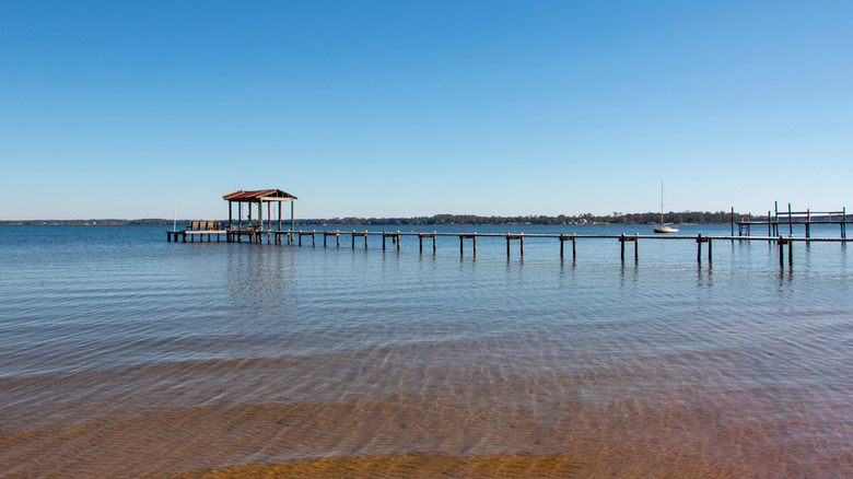 Pier extending to dock in waters of Lillian Alabama