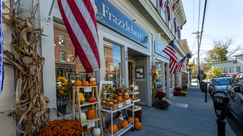 A bright fall day on Warwick, NY's main street, with the Frazzleberries store stocked with autumnal pumpkins, dried corn, and American flags.