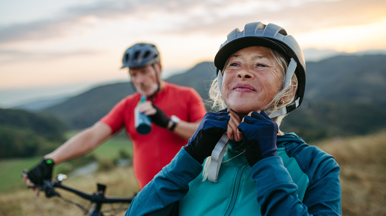 Older couple biking outdoors