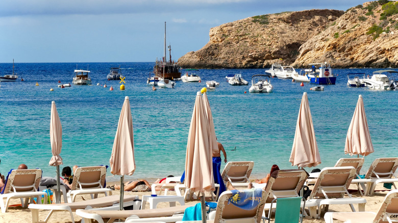 The sandy beach, warm Mediterranean waters and quiet cove of Vedella Beach on Ibiza's west coast