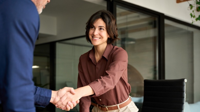 Women shaking hands at a bank