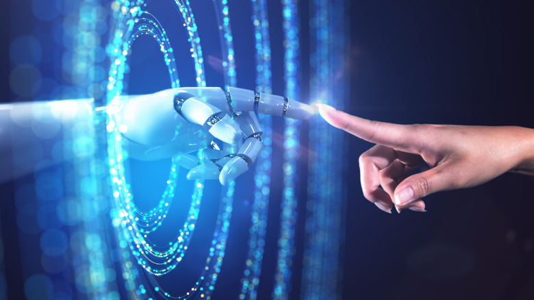 human and robot hand touching